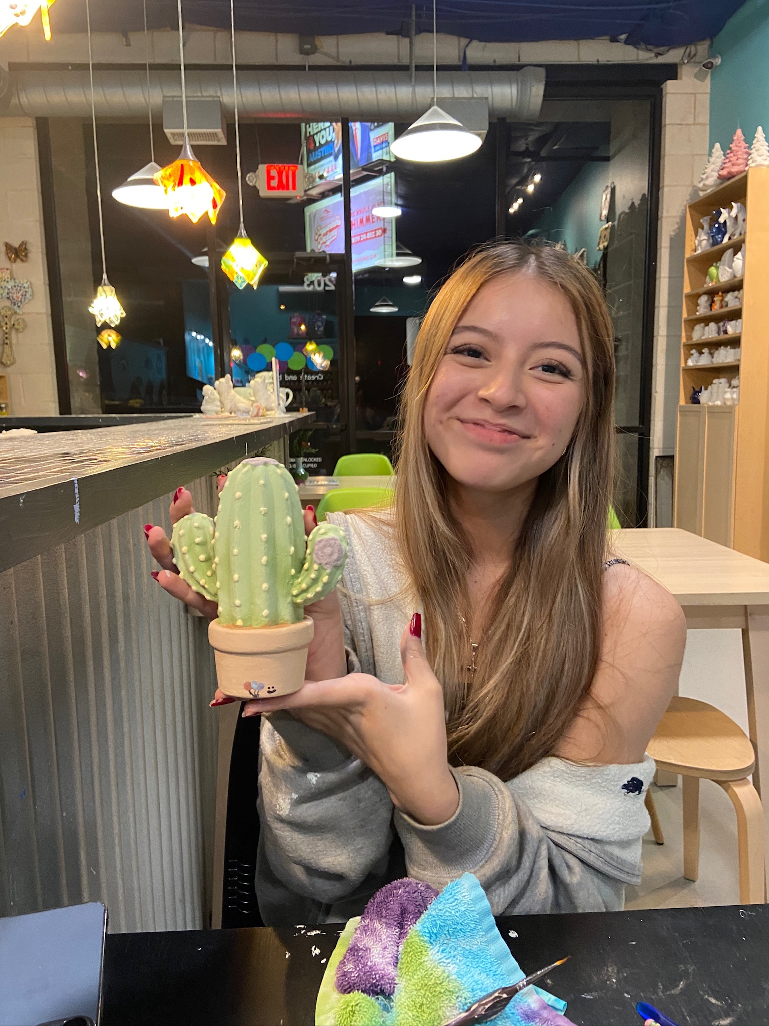 Melanie holding up Simon's cactus bank